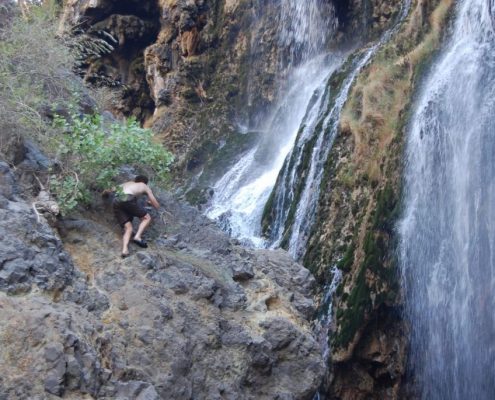 Climbing steep rocks with slippers like this adventurous Safari guest is not necessary to reach the Ngare Sero Waterfalls in the Lake Natron area.
