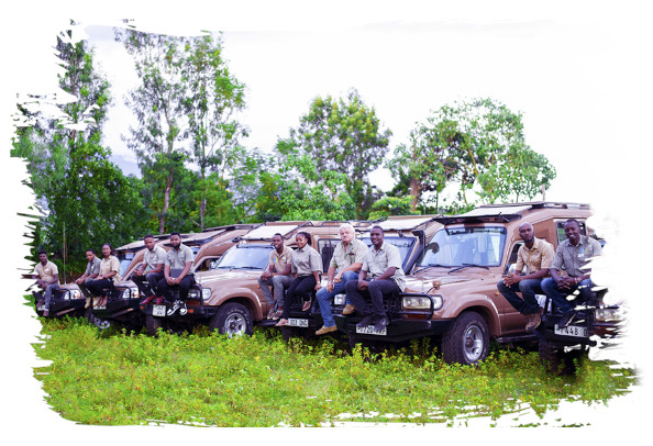 Our Safari guides and other staff sitting on the bonnet of several Shemeji Safari Trucks