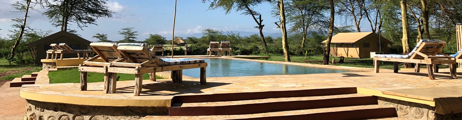 Jump into a nice swimming pool after a long trip in this Africa Safari accommodation